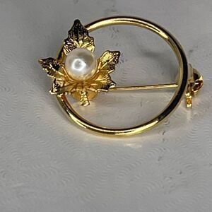 Vintage pearl adorned maple leaf open circle brooch.